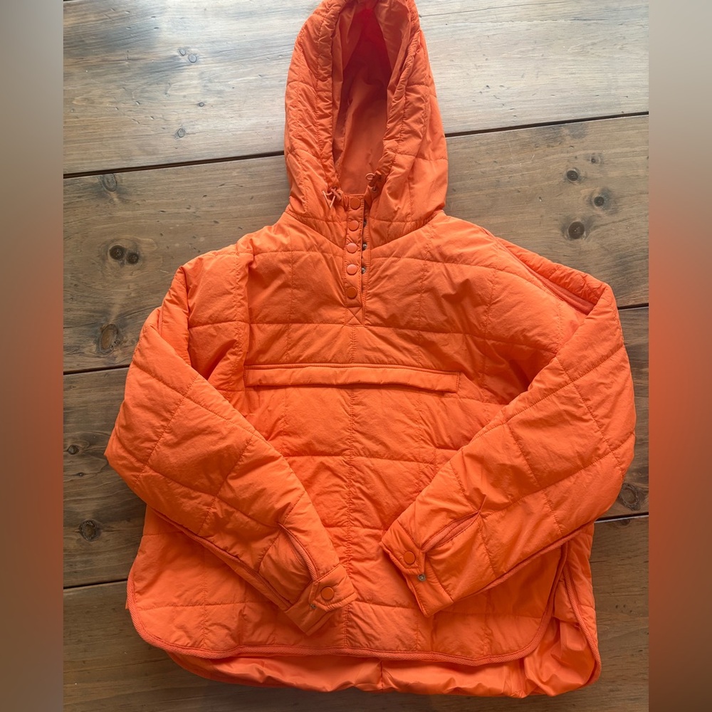Women’s large orange pullover jacket with hood.